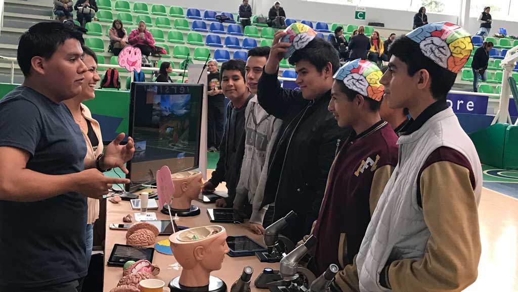 Photo of students wearing brain hats at a fair
