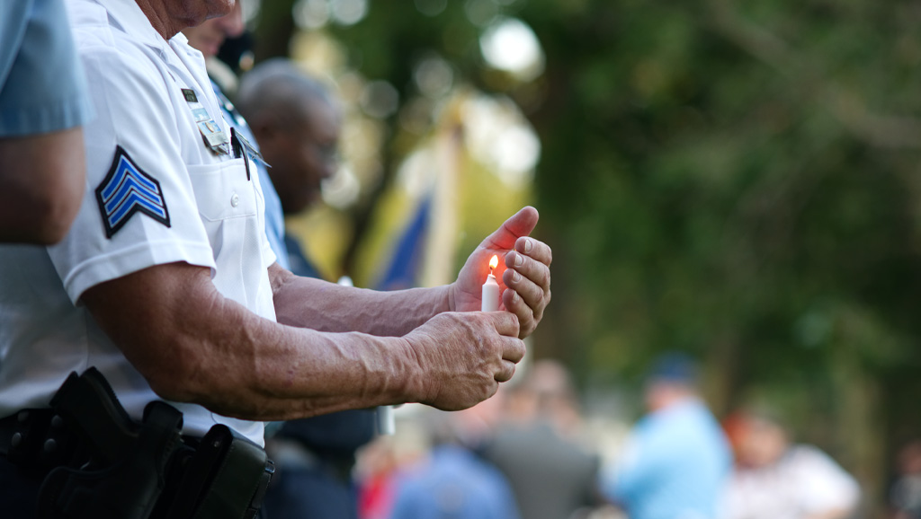 Cropped photo of military veteran holding candle for memorial