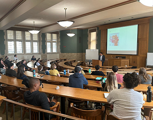 Students in a lecture hall listening to a presentation