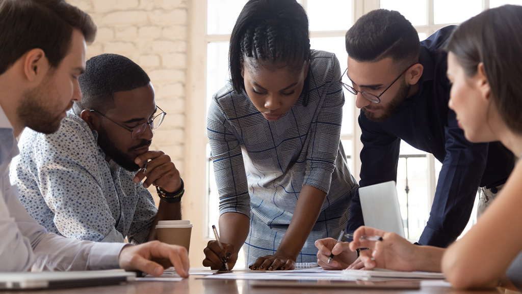 A group of young professionals looking at notes