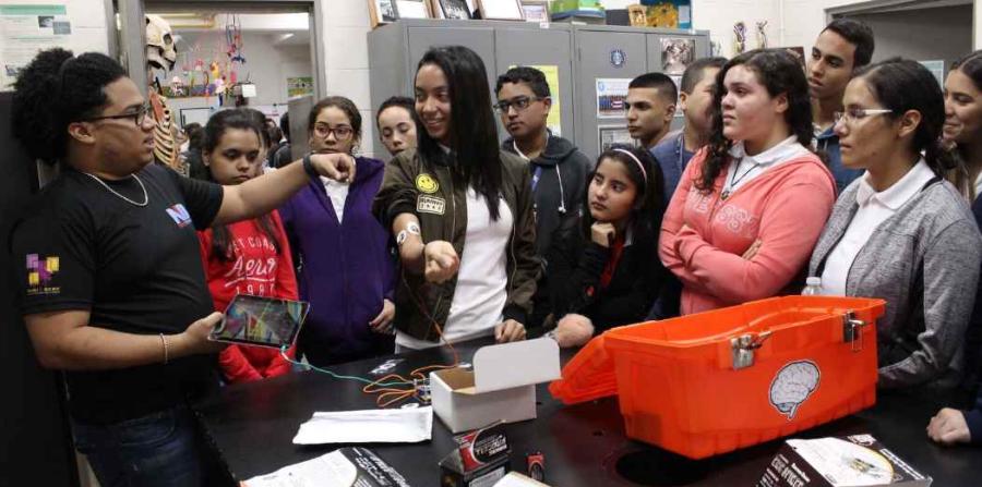 Group of high school students watching a neuroscience demonstration