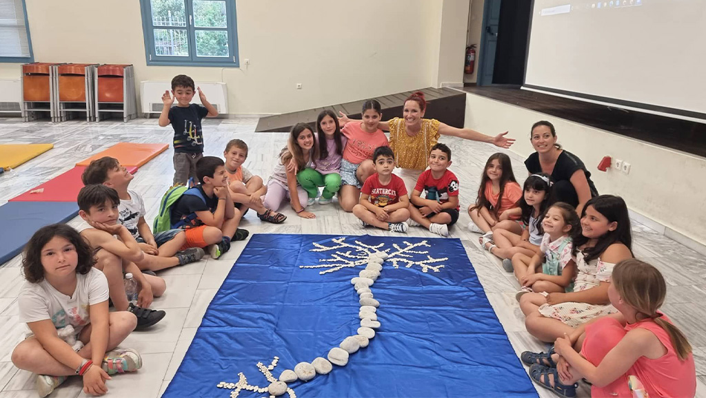 Photo of young students and teachers around a homemade neuron