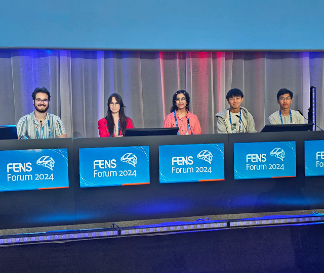 Students sitting on stage at FENS Forum